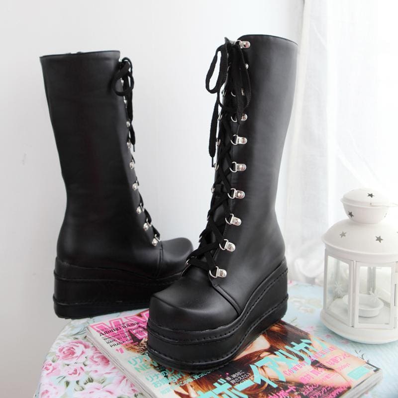 Black leather platform wedge boots with silver eyelets and chunky sole perfect for a bold moto look
