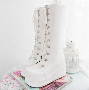 White platform moto boots with lace-up fronts and silver eyelets perfect platform wedge boots for edgy looks