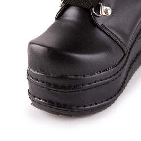 Black platform moto boots with shiny leather upper and stitched sole detail perfect as platform wedge boots