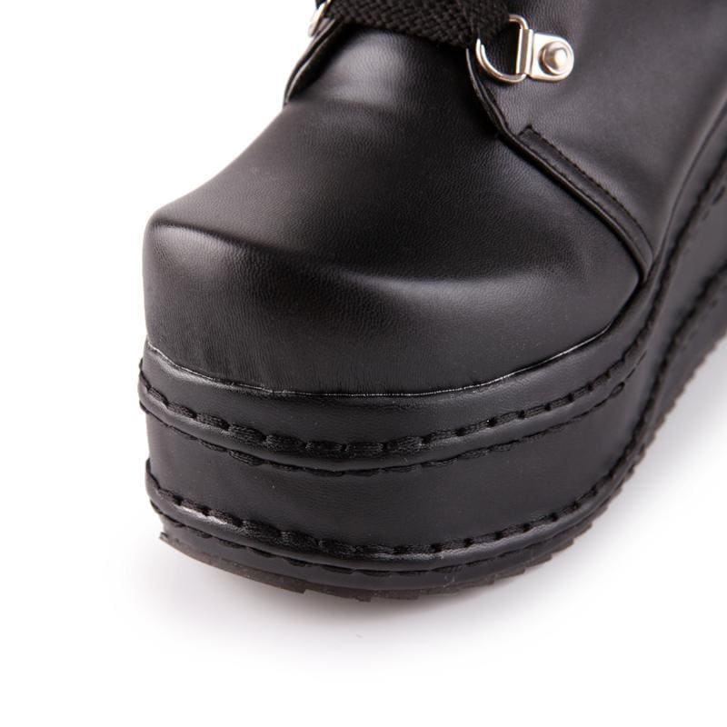 Black platform moto boots with shiny leather upper and stitched sole detail perfect as platform wedge boots