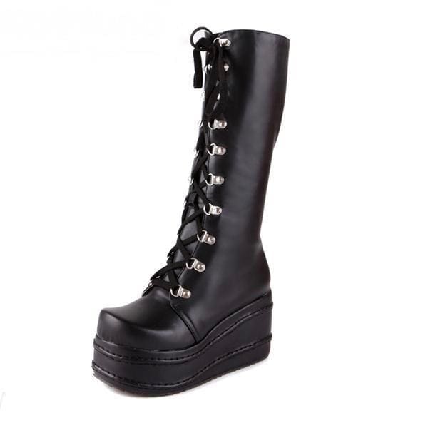 Black leather platform wedge boots with silver eyelets and thick wedge sole perfect for edgy looks