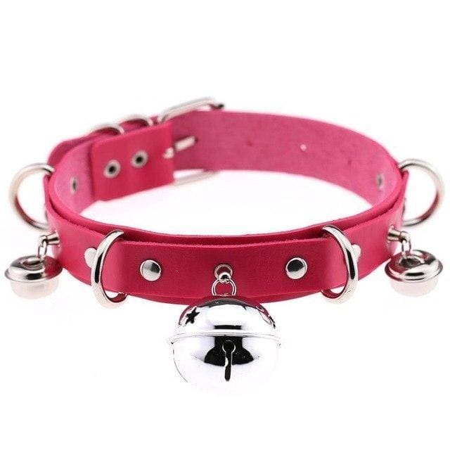 A vibrant pink pleather cat bell collar with shiny silver metal hardware and dangling bells for pets
