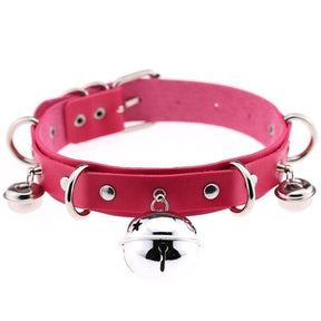 A vibrant pink faux leather bell collar for cats with silver metal hardware and dangling bells for playful pets