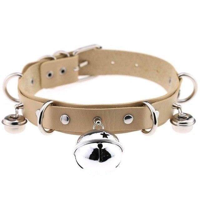 Beige pleather cat bell collar with silver metal hardware and dangling bells made of faux leather
