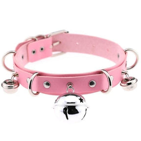 Pink pleather cat bell collar with silver metal hardware and dangling bells made from faux leather material