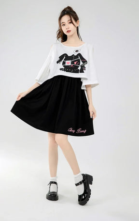 Black pleated bunny dress skirt with pink embroidered text at hem perfect for a two piece stunning look