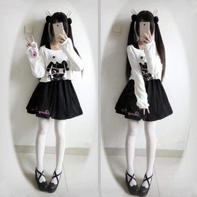 Black pleated bunny dress with pink embroidery and a white long sleeve evil top featuring a black cat graphic