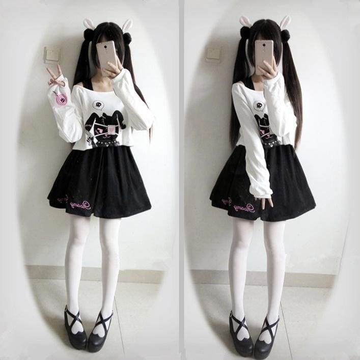 Black pleated bunny dress with pink embroidery and a white long sleeve evil top featuring a black cat graphic