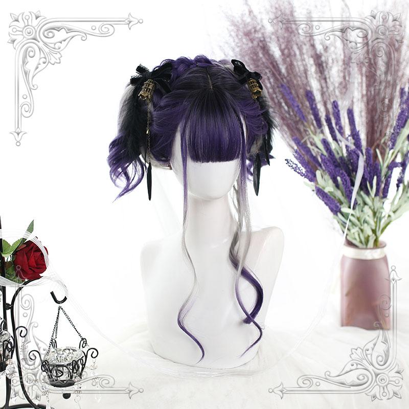 Purple and gray wig arranged in high curled side sections on a white mannequin, with straight bangs and long face-framing curls. Black bows and flowers are part of the styling.