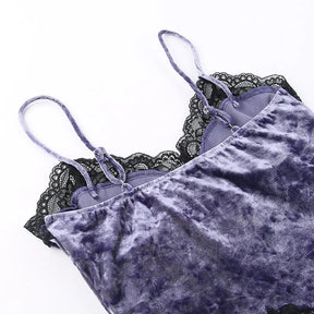 Rear strap detail showing the small adjustment sliders on the purple camisole and the lace-trimmed front beyond.