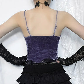 Back of the purple camisole, showing its straight upper edge and slim straps above a black ruffled skirt.