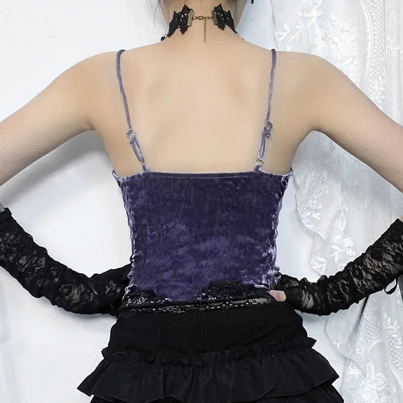 Back of the purple camisole, showing its straight upper edge and slim straps above a black ruffled skirt.