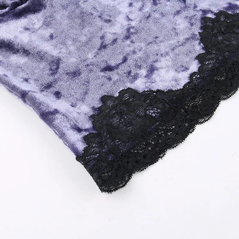 Angled detail of the lower purple velvet panel and its wide black floral lace edge.