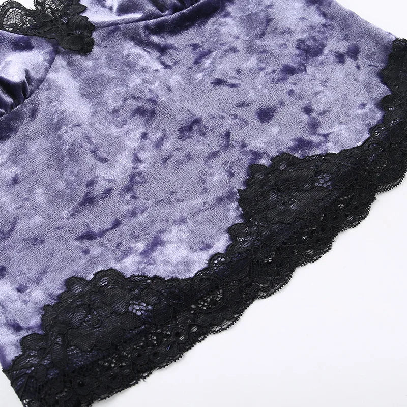 Close-up of black floral lace bordering the purple crushed velvet camisole hem.