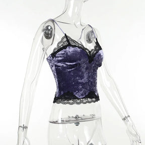 Side angle of the purple velvet camisole on a clear mannequin, showing the curved bust and lace-trimmed hem.