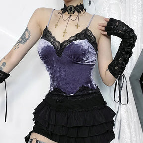 Purple crushed velvet camisole worn with one hand near the shoulder, highlighting the scalloped lace neckline and bust seams.