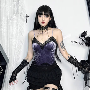 Purple camisole styled with a black tiered skirt, lace arm warmers and a statement choker in a pale gothic room.
