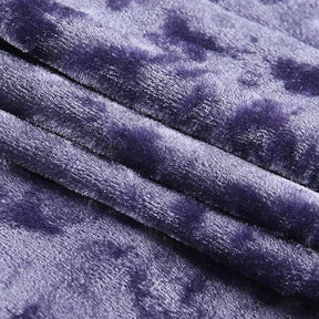 Close-up of the purple camisole's crushed velvet surface folded into soft ridges.