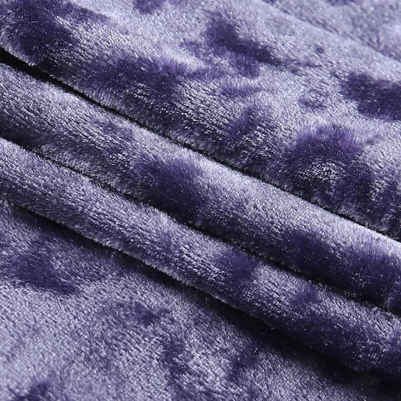 Close-up of the purple camisole's crushed velvet surface folded into soft ridges.
