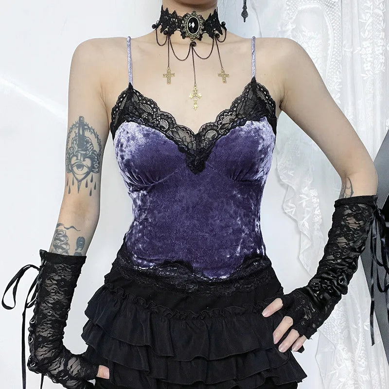 Front view of the purple lace camisole with a hand at the waist, showing its fitted outline and scalloped lower edge.