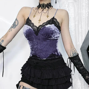 Purple crushed velvet camisole with black scalloped lace at the neckline and hem, worn with a tiered black skirt and lace arm warmers.