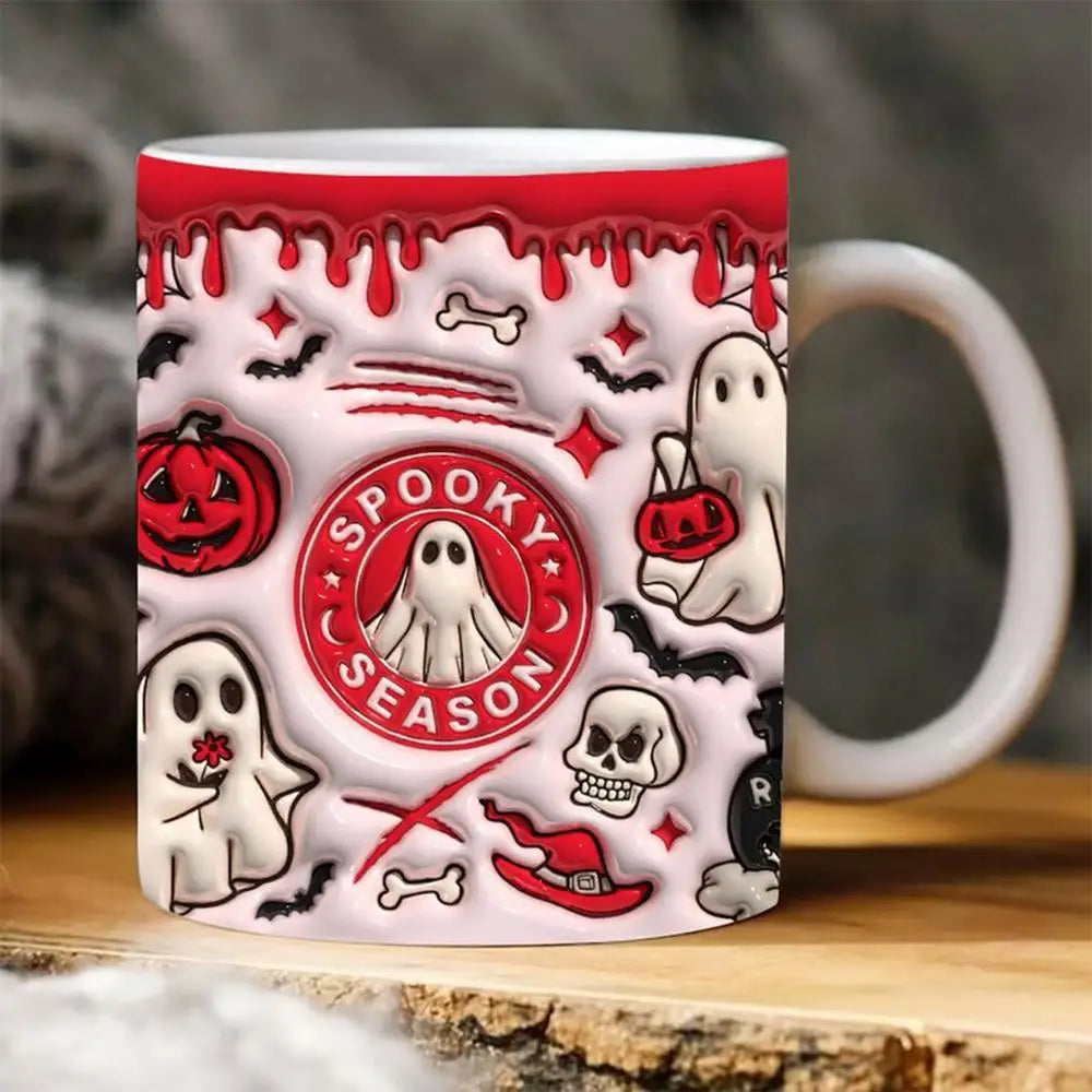 Red Spooky Season ghost mug with a white handle, pictured on a wooden surface with pumpkin, bat and skull artwork.
