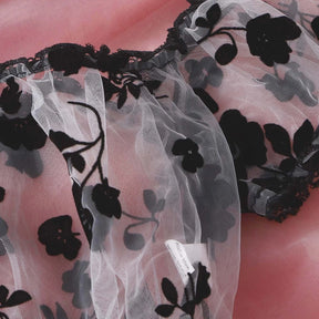 Gathered neckline and black lace edging on the floral off-shoulder lingerie top.