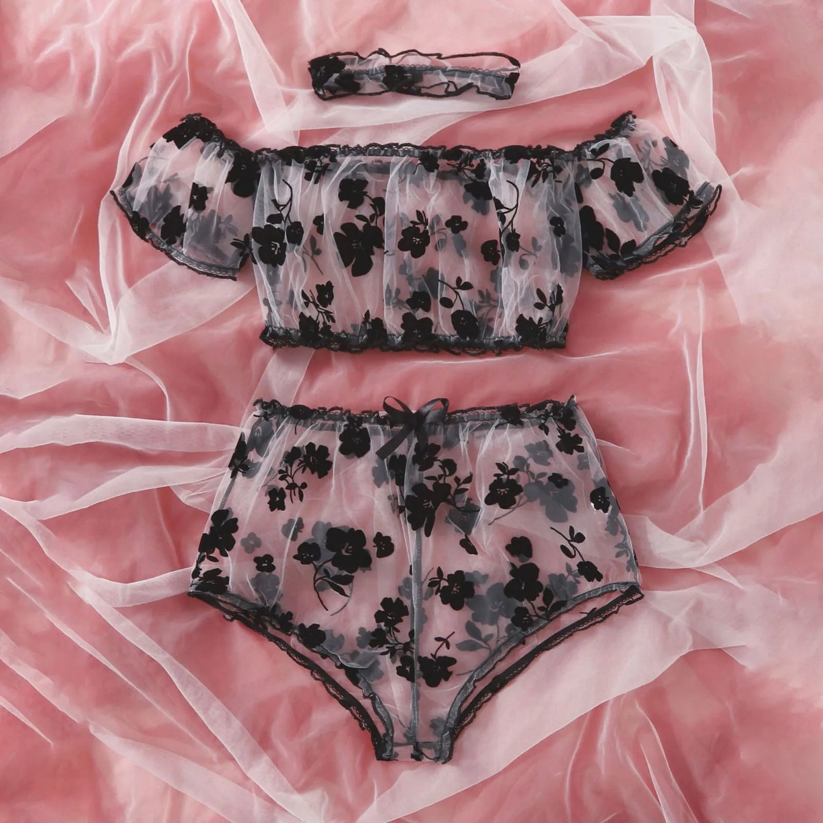 Front view of the off-shoulder floral lingerie top and ruffled briefs with black trim.