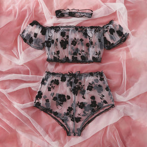 Front view of the off-shoulder floral lingerie top and ruffled briefs with black trim.