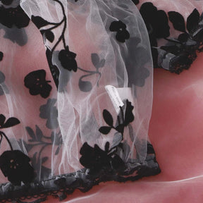 Short puff sleeve on the sheer black floral lingerie top, finished with black trim.