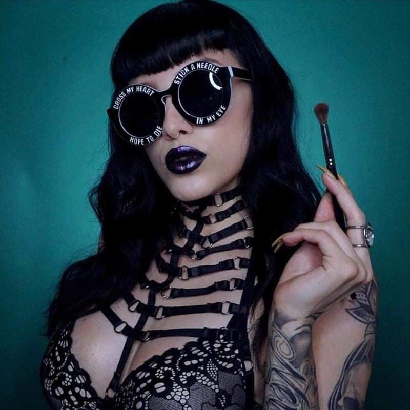 Black round ribbed harness sunglasses with white text cross my heart hope to die stick a needle in my eye