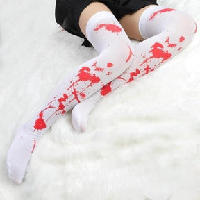 White thigh-high skeleton bone stockings with red splatter patterns perfect for spooky bone stockings look