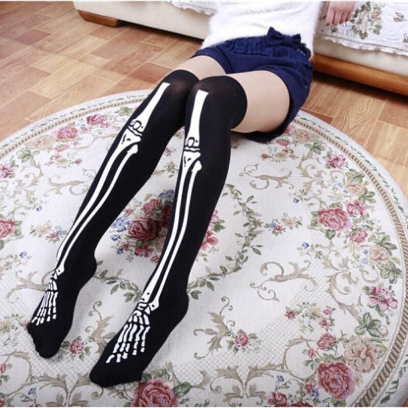 Black thigh-high skeleton bone stockings with white skeletal design on legs and feet perfect for spooky looks