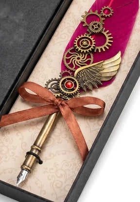 Red steampunk quill close-up showing gear ornaments, wing detail and writing nib