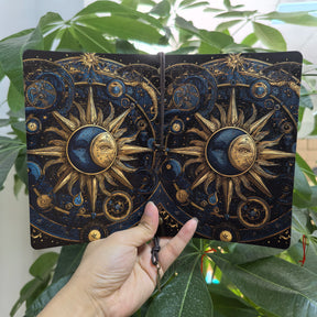 Sun and moon notebook opened to show the matching celestial artwork across its front and back covers.