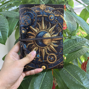 Closer view of the celestial journal’s sunburst and crescent artwork with the cord wrapped across the centre.