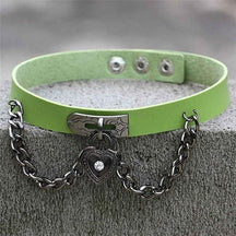 Victorian locket choker with a lime green leather band, black chain, and heart locket pendant in edgy style