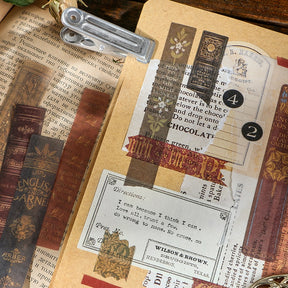 A journal collage combines long book-spine stickers with old advertising and printed paper details on a clipboard.