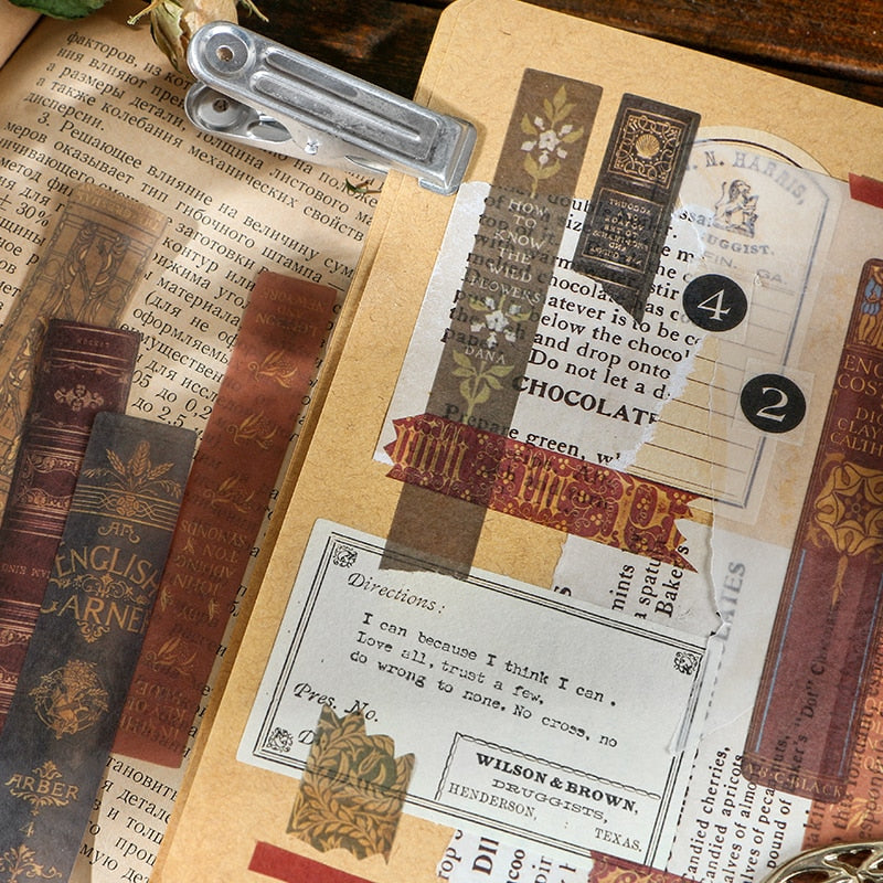A journal collage combines long book-spine stickers with old advertising and printed paper details on a clipboard.