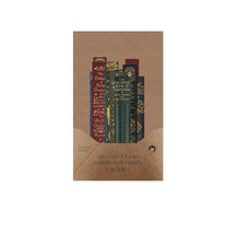 Brown decorative sticker packet filled with narrow book-spine designs in muted burgundy, green and gold-toned print.