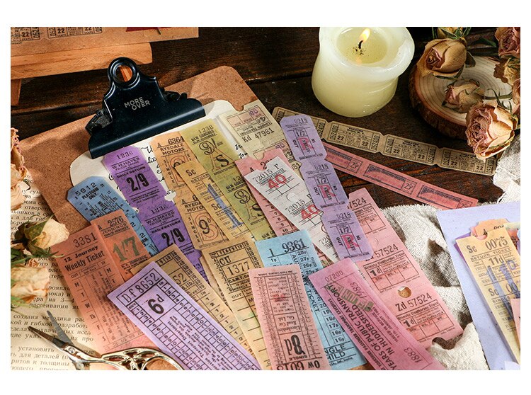 Pink, yellow, blue and purple ticket stickers arranged across a clipboard with repeated vintage-style numbers and print.