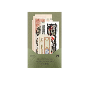 Muted green packet of vintage decorative stickers, with illustrated labels and long ornamental strips visible above the envelope.
