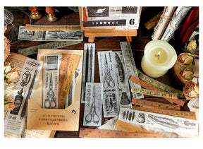 Long vintage illustration stickers displayed around a tan packet, with narrow black drawings and old text on pale backgrounds.