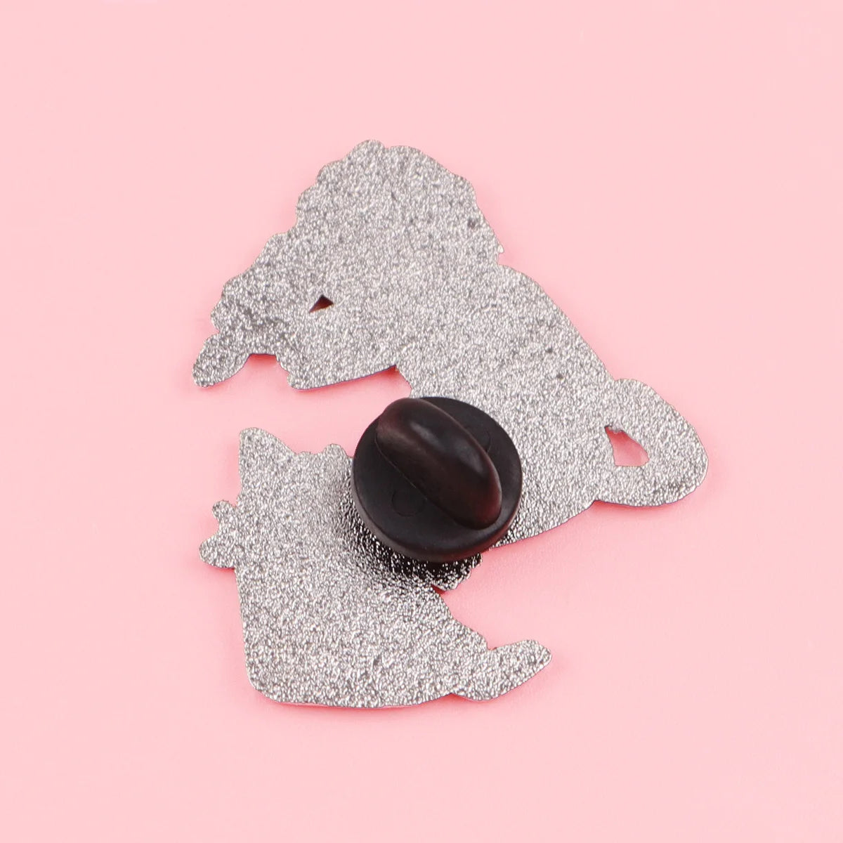 Back of the witch cat enamel pin showing its single black clutch fastening