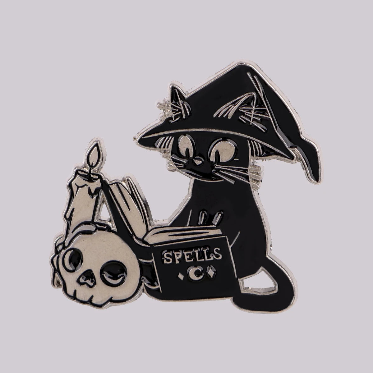 Witch cat spellbook enamel pin with a pointed hat, candle and skull detail
