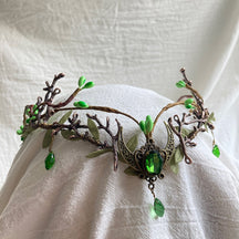 Brown woodland tiara with green buds, branching antlers and a dark green oval accent set in a crescent with a hanging drop.