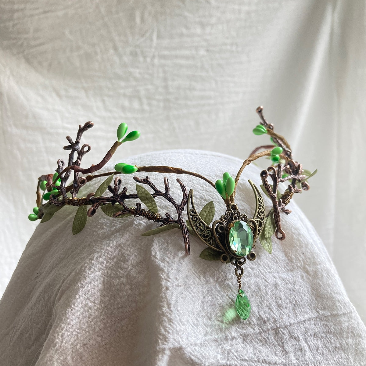 Leafy woodland tiara with branching antlers, a crescent centre and pale green oval accent with a matching hanging drop.