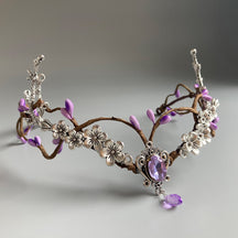 Silver-tone antler tiara with purple buds, a row of small flower ornaments and a faceted purple central detail.