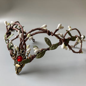 Branch-style elf tiara with pale buds, green leaves and a bright red round centre accent.