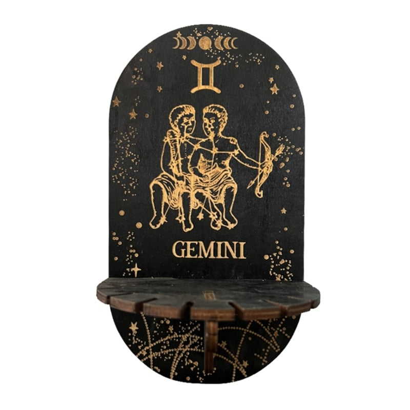 Black wall display shelf with gold-tone Gemini twins, zodiac symbol, stars and GEMINI lettering above a small ledge.